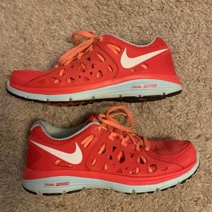 Nike Dual Fusion Running Shoe. Kind of a Coral color. Good used condition.